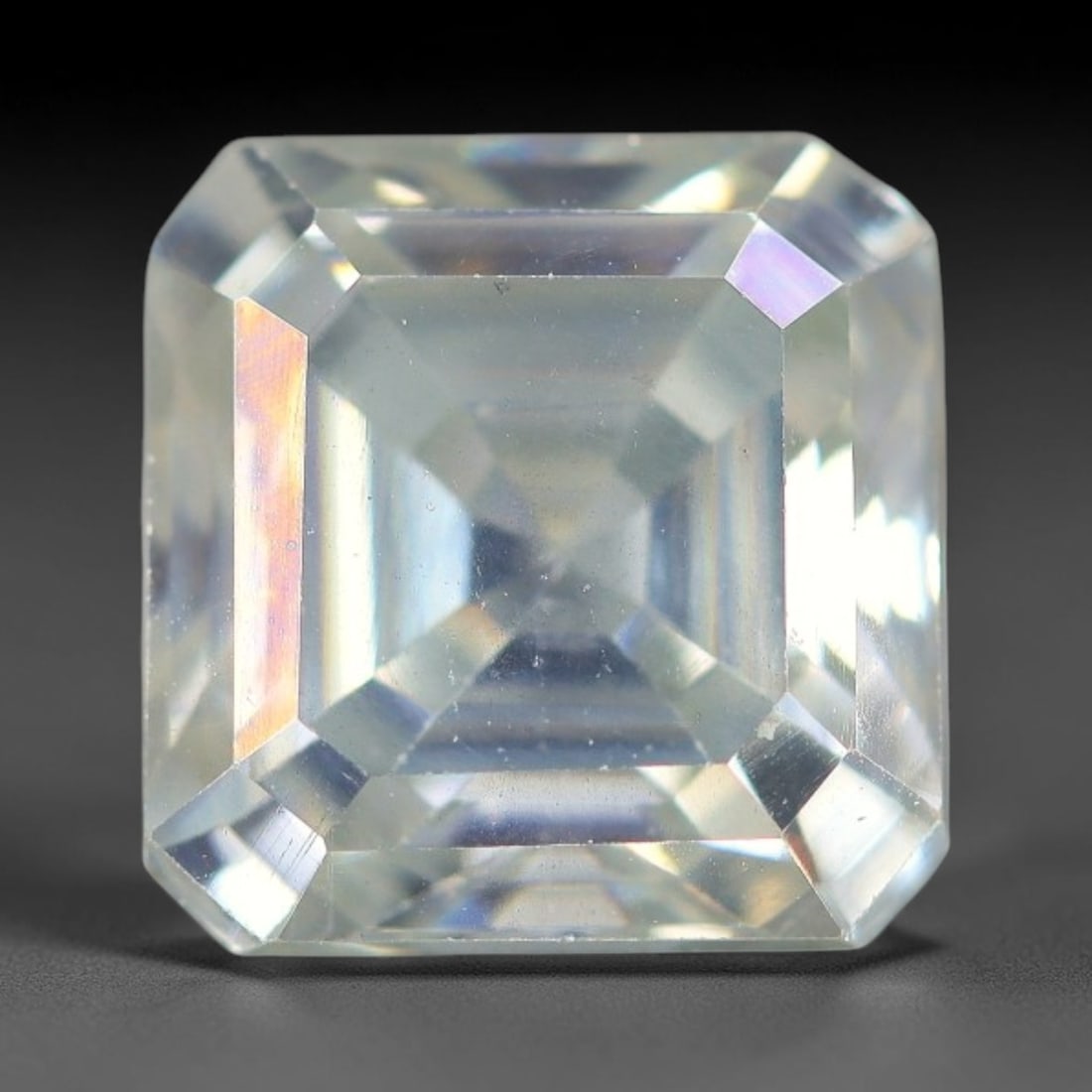 2.44 Carats Natural Cool White Moissanite Loose Gemstone, 1FP: This cool white moissanite holds dimension measurements of 7.7x4.8mm, delivering exceptional light dispersion that generates vivid rainbow sparkle across its fully transparent body, with faint microsc