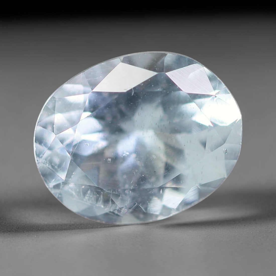 1.74ct Natural Brazilian Sky Blue Faceted Aquamarine Loose Gemstone, 5BF: This precisely faceted aquamarine boasts clear translucent pale sky blue body tone with subtle thin mineral needle and tiny scattered crystalline specks visible within its polished reflective planes i