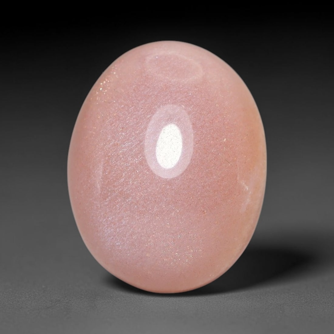 12.73ct Natural Ceylon Warm Peach Moonstone Loose Gemstone, 90FX: This natural Ceylon moonstone has dimension measurements of 17x13x8mm, showcasing a smooth warm peach base tone paired with subtle soft adularescent sheen that glides gently across the polished surfac