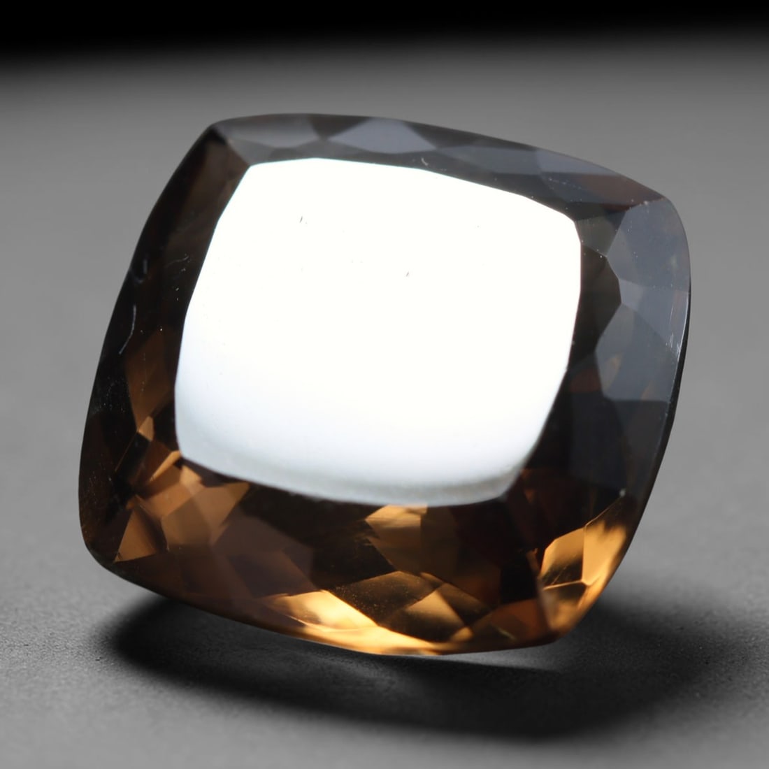 16.50ct Natural Brazilian Smoky Quartz Cushion Faceted Loose Gemstone, 72BZ: This cushion-shaped faceted gemstone is natural smoky quartz originating from Brazil. It displays a lovely gradient warm smoky brown tone transitioning between deeper taupe and glowing amber shades wi