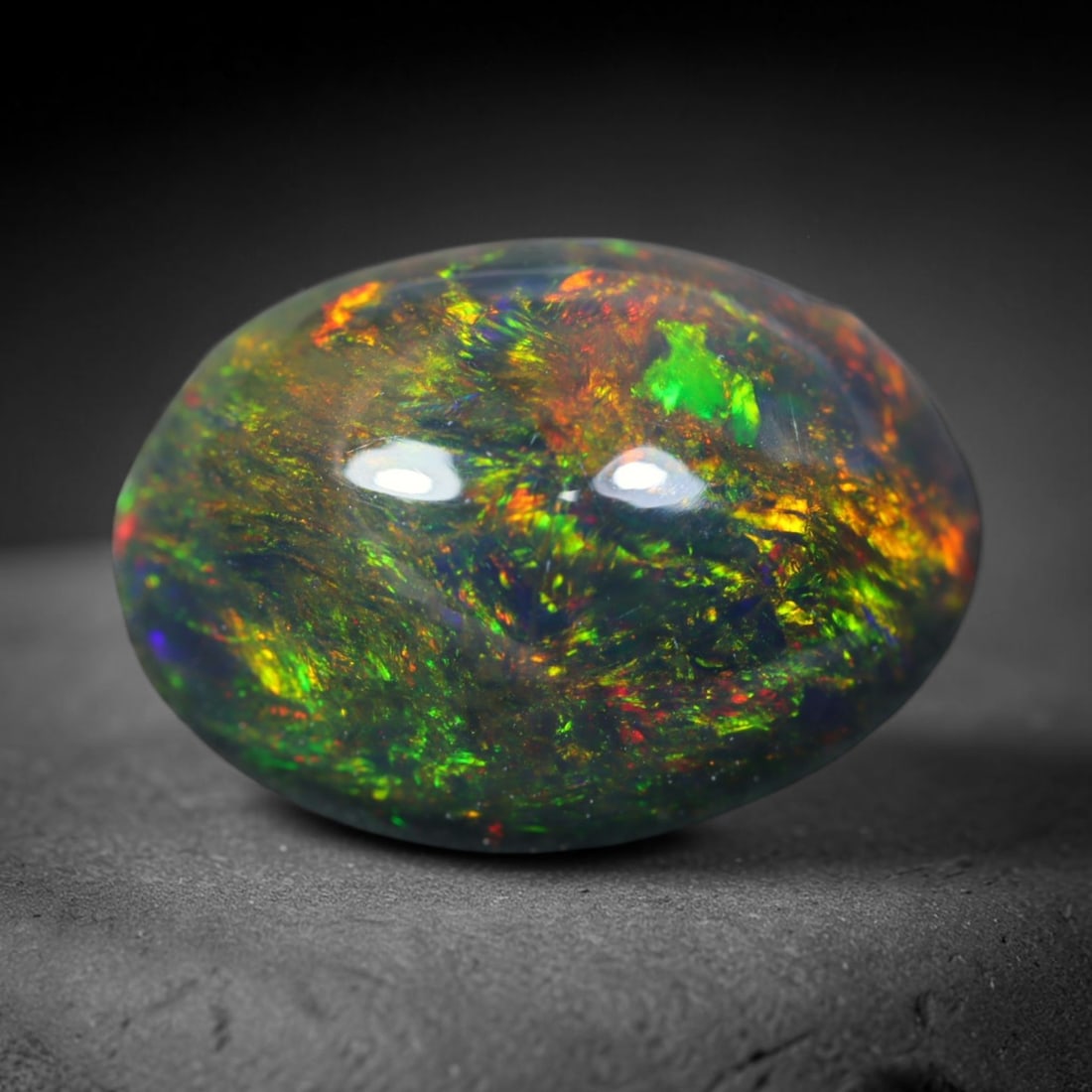 2.28ct Natural Ethiopian Welo Black Smoked Opal Cabochon Loose Gemstone, 32FL: This fully polished Ethiopian Welo opal features a dark smoked base with vivid, sweeping play-of-color shifting across its glossy dome surface, measured at 11.1x8.6x5.5mm. The black smoke treatment de