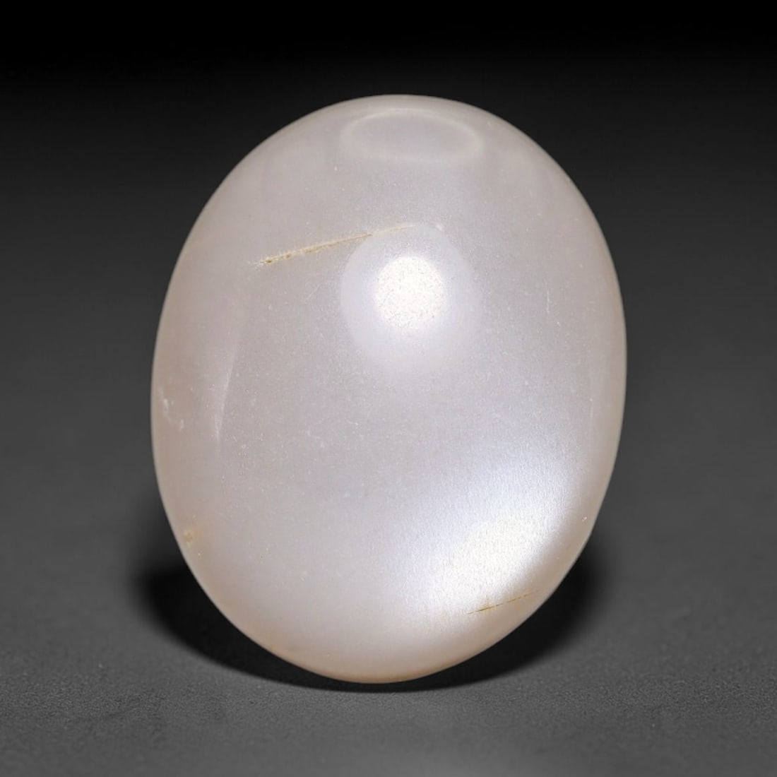 11.10ct Natural Ceylon Grey Moonstone Cabochon Loose Gemstone, 91FX: This natural Ceylon moonstone cabochon carries a soft grey body showcasing classic adularescence. Fine mineral inclusions are visible within the gem. Dimensions measure 16x13x7mm, mined in Sri Lanka, 