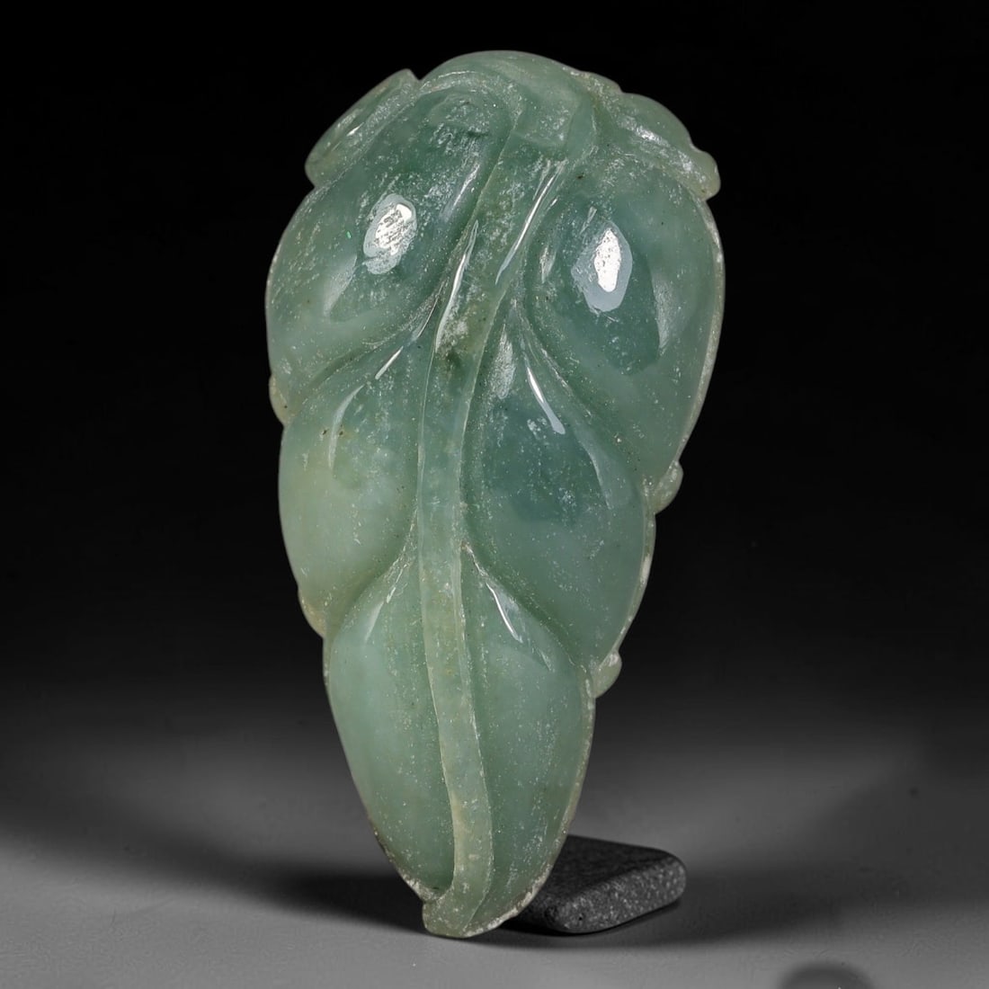 Natural Burmese Type A Hand Carved Jadeite Jade Leaf Pendant, 88AT: Exquisitely hand-sculpted natural Burmese Type A jadeite jade pendant shaped as a full natural leaf motif, measuring 32 x 17 mm. Fine polished relief carving details the central vein and layered leaf 