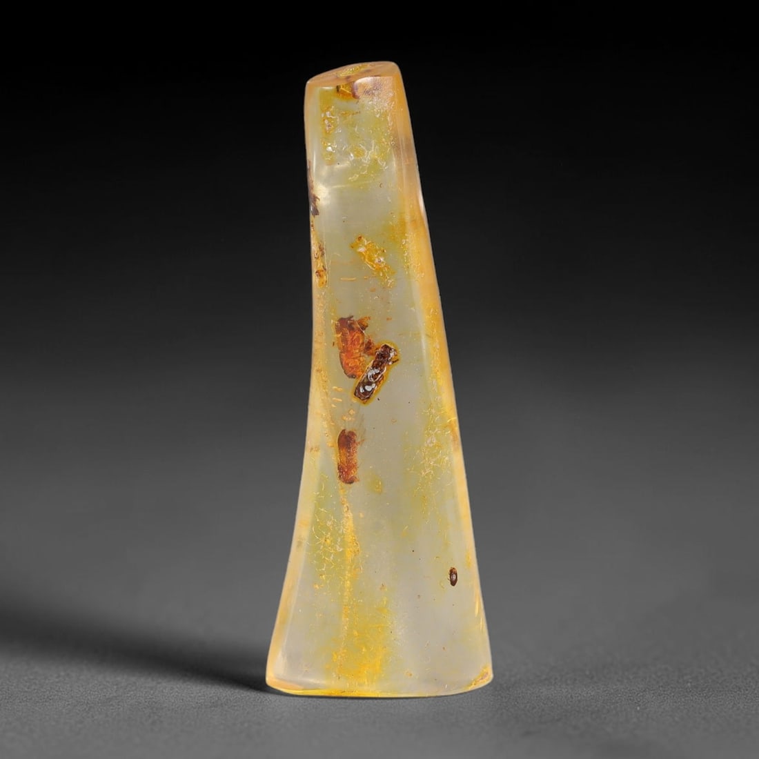 8.32ct Natural Baltic Polished Loose Freeform Amber Gemstone, 68FL: This smoothly polished freeform amber piece carries warm translucent organic clarity with fine natural fossil flecks and tiny mineral inclusions suspended throughout its 38x13x6mm flowing unstructured