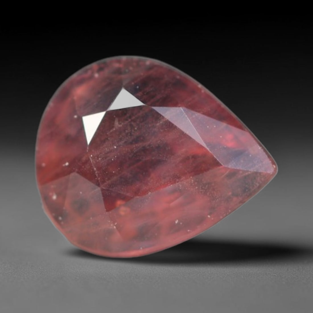0.68ct Natural Sri Lankan Padparadscha Sapphire Loose Gemstone, 62BC: This fully polished Padparadscha sapphire carries warm blended peach-pink and soft orange body saturation, with subtle microscopic mineral flecks dispersed within its crystalline interior across its c