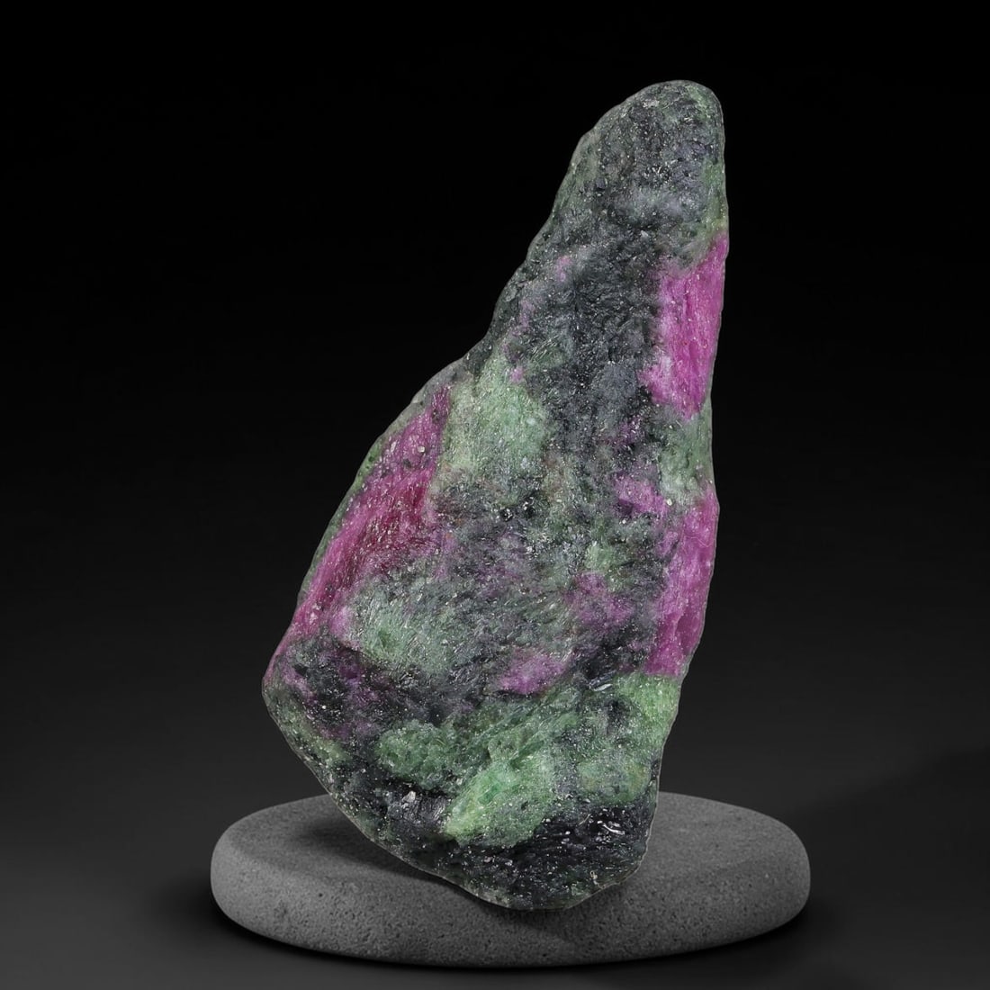 107ct Natural Tanzanian Ruby Zoisite Raw Rough Specimen Mineral Stone, 93FB: This unpolished mineral rough is natural ruby zoisite sourced from Tanzania, exhibiting distinct banded mineral segregation of vibrant green zoisite, magenta ruby crystals, and dark hornblende inclusi
