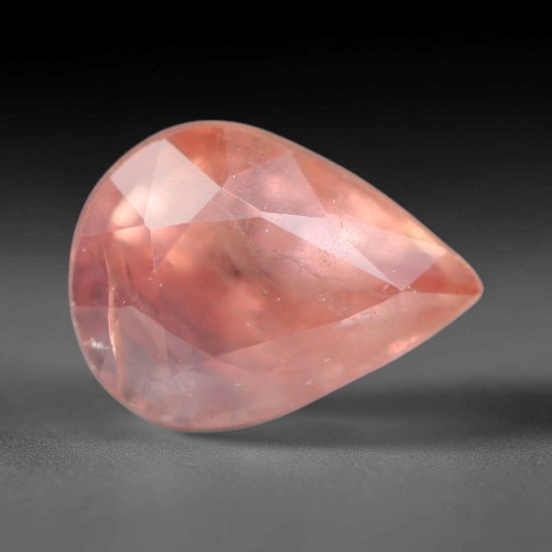 0.75ct Natural Sri Lankan Padparadscha Sapphire Loose Gemstone, 51BC: This fully polished Padparadscha sapphire carries warm blended peach-pink and soft orange body saturation, with subtle microscopic mineral flecks dispersed within its crystalline interior across its c