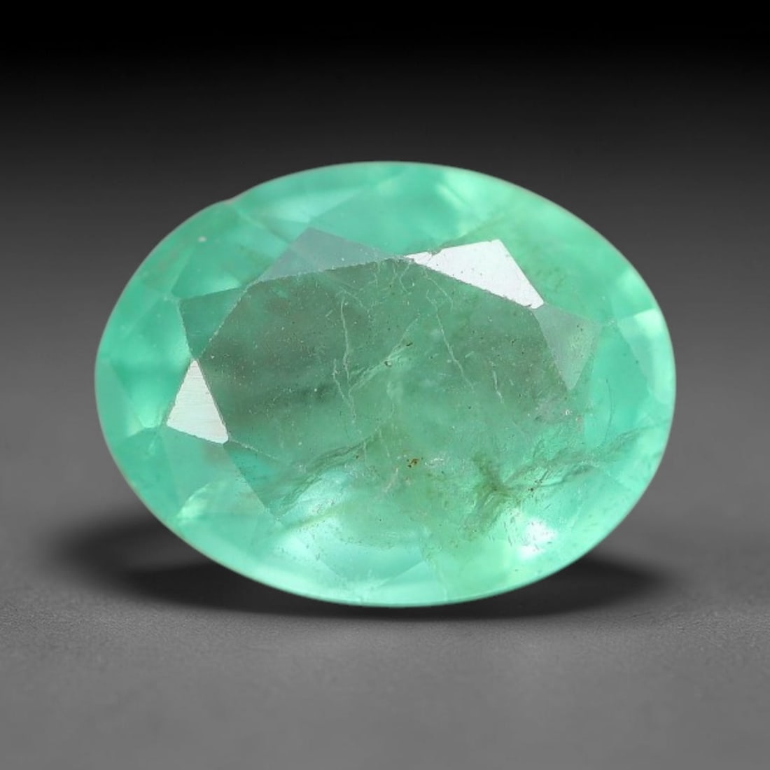 1.19 Carats Natural Zambian Green Emerald Loose Gemstone, 11FP: This green Zambian emerald holds smooth even saturation with subtle faint natural internal markings lending authentic organic character, measured at 8x6.1x3.6mm, its calm cool green tone delivers unde