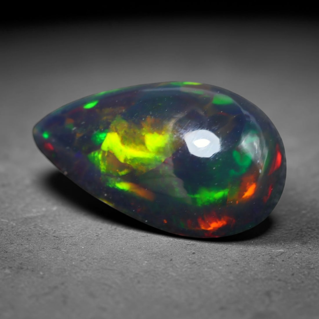 2.96ct Natural Ethiopian Welo Black Smoked Opal Cabochon Loose Gemstone, 66BY: This fully polished Ethiopian Welo opal features a dark smoked base with vivid, sweeping play-of-color shifting across its glossy dome surface, measured at 13x8x6mm. The black smoke treatment deepens 