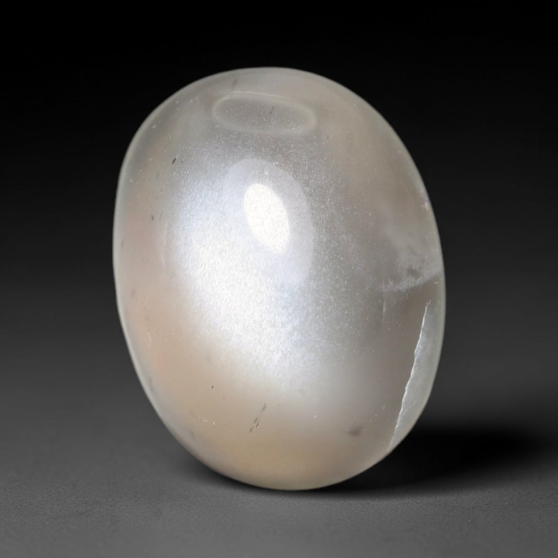 7.81ct Natural Ceylon Grey Moonstone Cabochon Loose Gemstone, 92FX: This natural Ceylon moonstone cabochon carries a soft grey body showcasing classic adularescence. Fine mineral inclusions are visible within the gem. Dimensions measure 14x11x6mm, mined in Sri Lanka, 