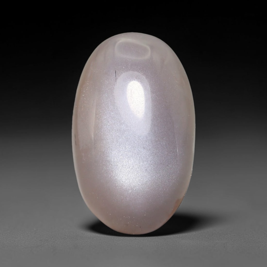 15.62ct Natural Ceylon Grey Moonstone Cabochon Loose Gemstone, 94FX: This natural Ceylon moonstone cabochon carries a soft grey body showcasing classic adularescence. Fine mineral inclusions are visible within the gem. Dimensions measure 20x13x8mm, mined in Sri Lanka, 