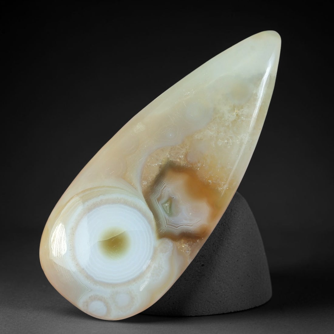 69.74ct Natural Gobi Desert Eye Agate Teardrop Cabochon, 81AV: Single fully natural untreated Gobi desert agate teardrop cabochon weighing 69.74ct with dimensions 53x22mm. This polished gemstone features a striking complete circular eye formation with concentric 