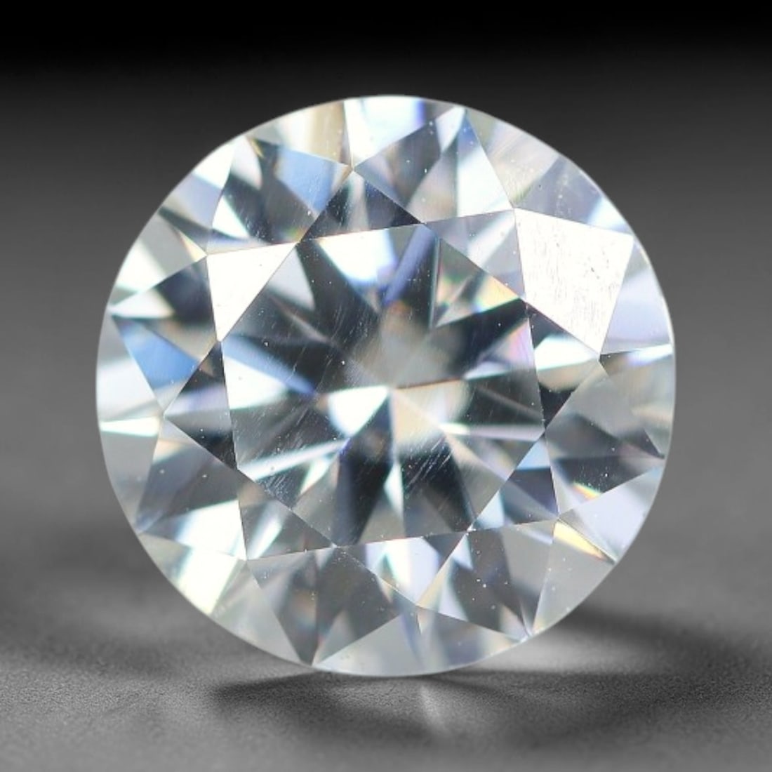 1.20 Carats Natural Cool White Moissanite Loose Gemstone, 92FM: This cool white moissanite holds dimension measurements of 7x4.2mm, delivering exceptional light dispersion that generates vivid rainbow sparkle across its fully transparent body, with faint microscop