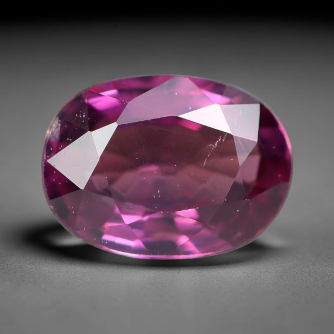 1.02ct Natural Tanzanian Rhodolite Grape Garnet Faceted Loose Gemstone, 11BE: This expertly faceted grape garnet, a scarce saturated purple-magenta rhodolite variant, features transparent crystal structure dotted with faint microscopic mineral specks within its precisely cut re