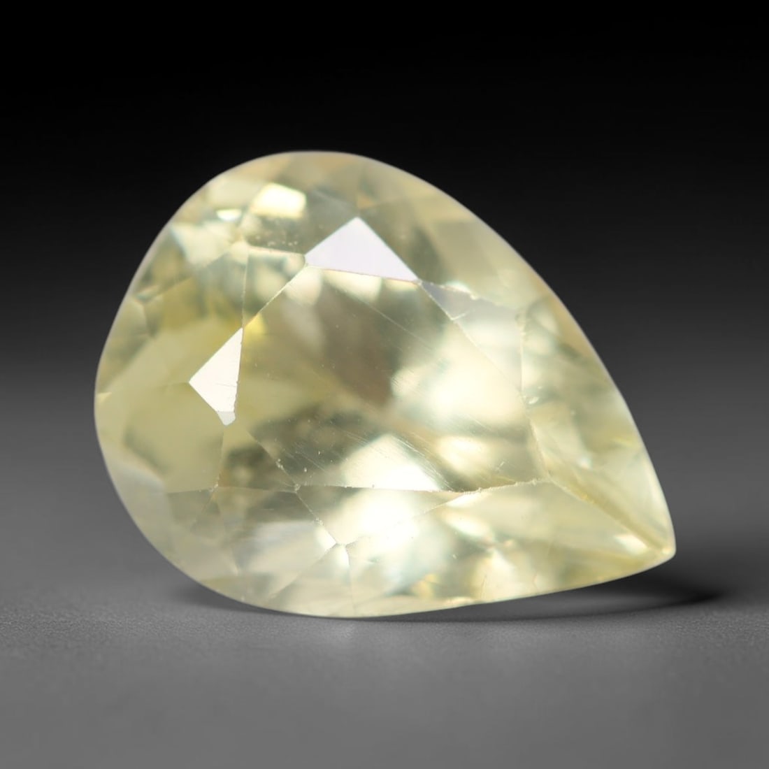 2.94ct Natural Mexican Lemon Yellow Faceted Apatite Loose Gemstone, 81AR: This expertly faceted yellow apatite holds translucent pale lemon yellow crystal structure with faint tiny internal mineral specks and subtle fine linear markings visible beneath its precisely polishe
