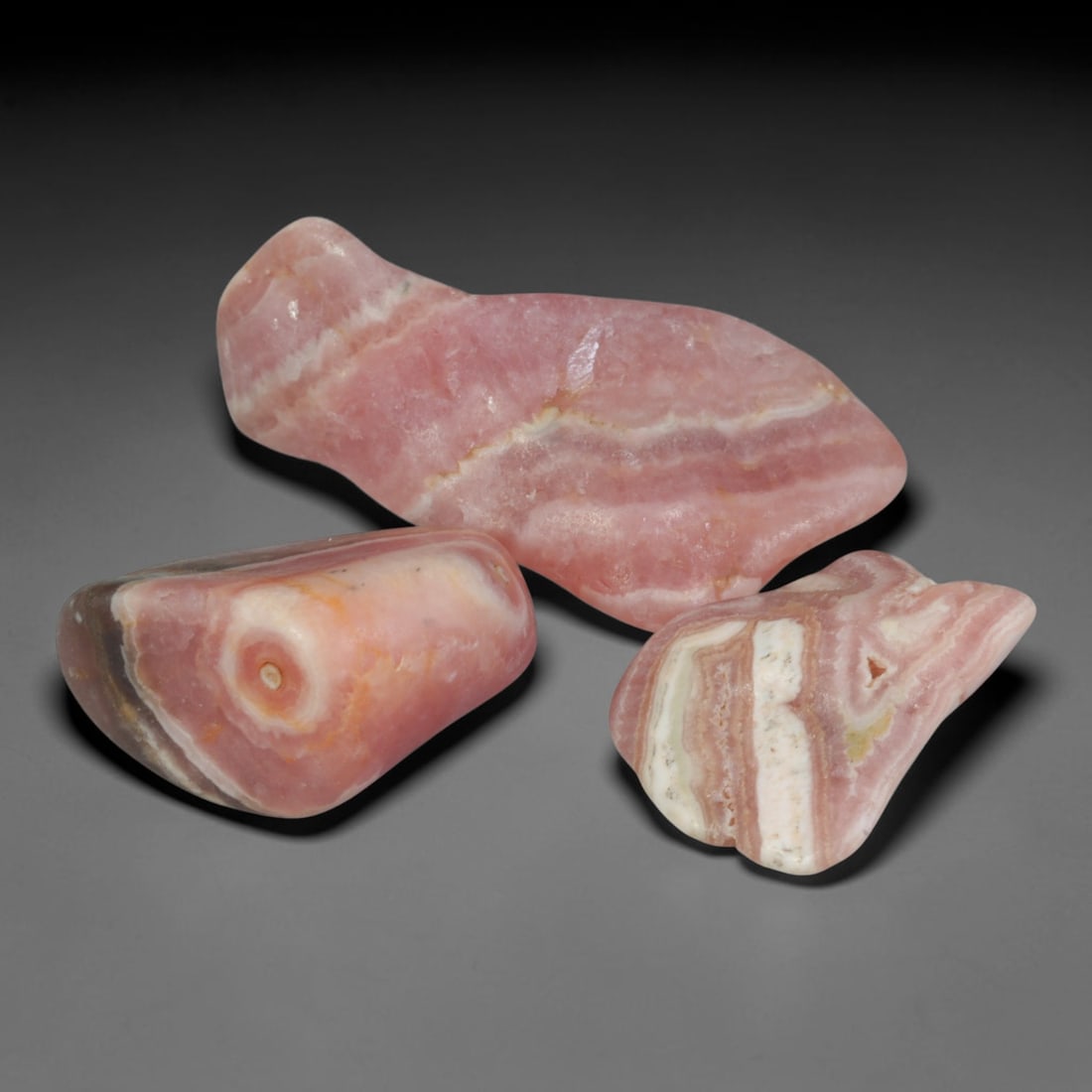 50ct 3pcs Natural Argentine Rhodochrosite Banded Tumbled Rough Set, 16FD: This listing features three individual tumbled rhodochrosite rough pieces sourced from Argentina Capillitas deposits, each showcasing distinct layered banding of soft rose pink, cream white and pale t