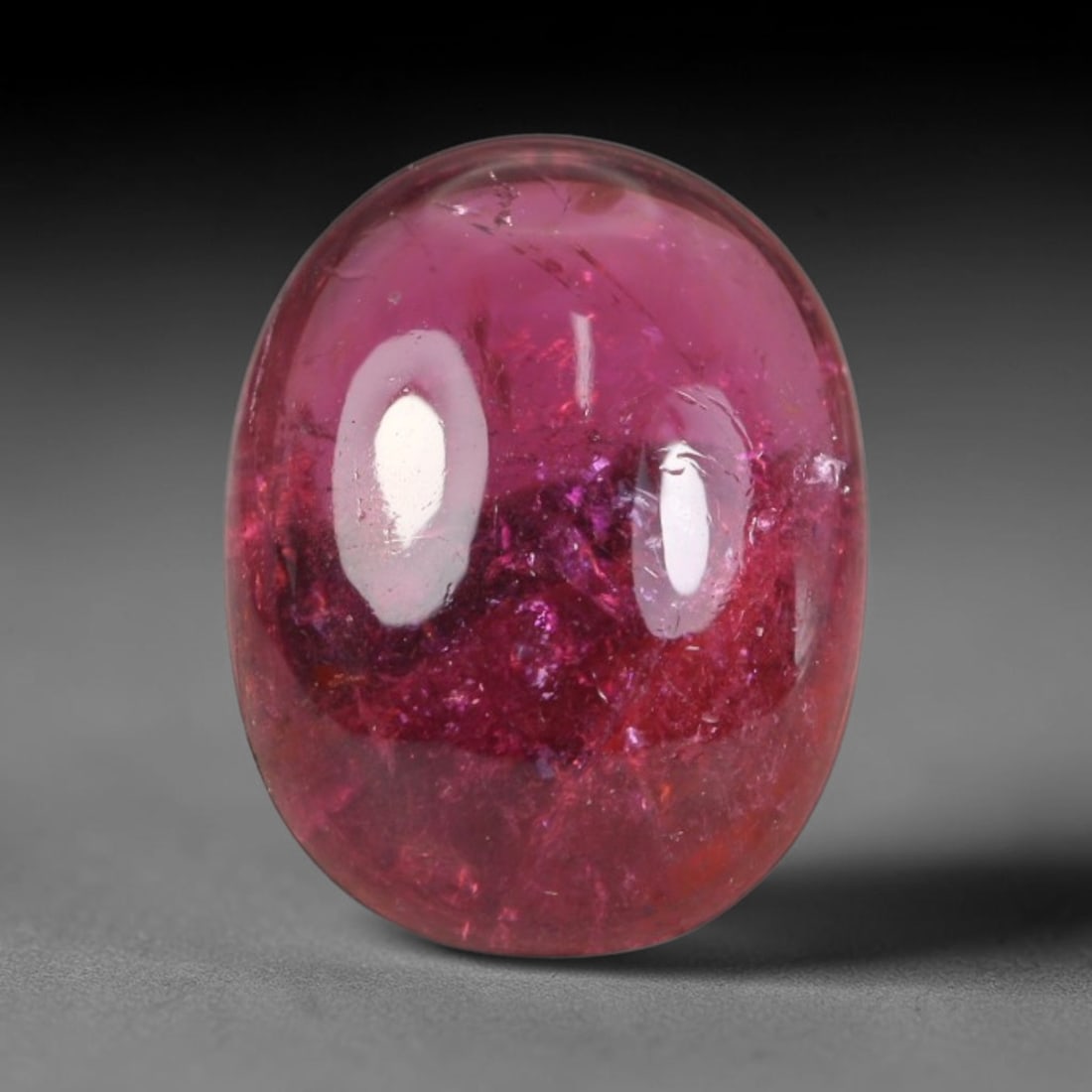2.29ct Natural Brazilian Rubellite Tourmaline Cabochon Loose Gemstone, 21BC: This smoothly polished cabochon rubellite tourmaline features layered saturated pink-red body saturation with dense natural crystalline mineral flecks and fine internal fracture markings concentrated 