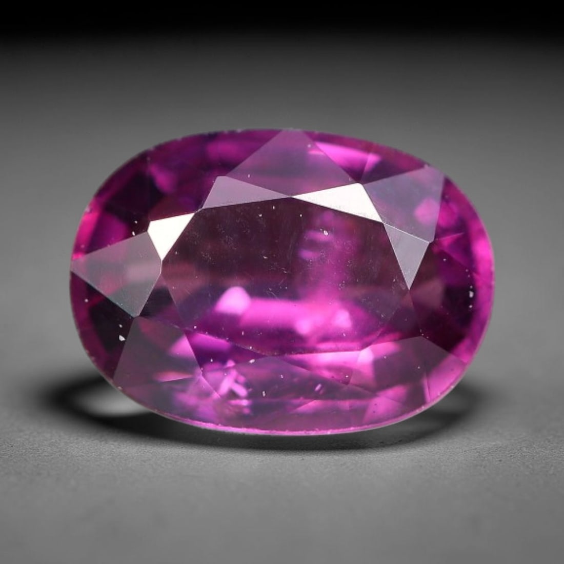 1.14ct Natural Tanzanian Rhodolite Grape Garnet Faceted Loose Gemstone, 96BF: This expertly faceted grape garnet, a scarce saturated purple-magenta rhodolite variant, features transparent crystal structure dotted with faint microscopic mineral specks within its precisely cut re