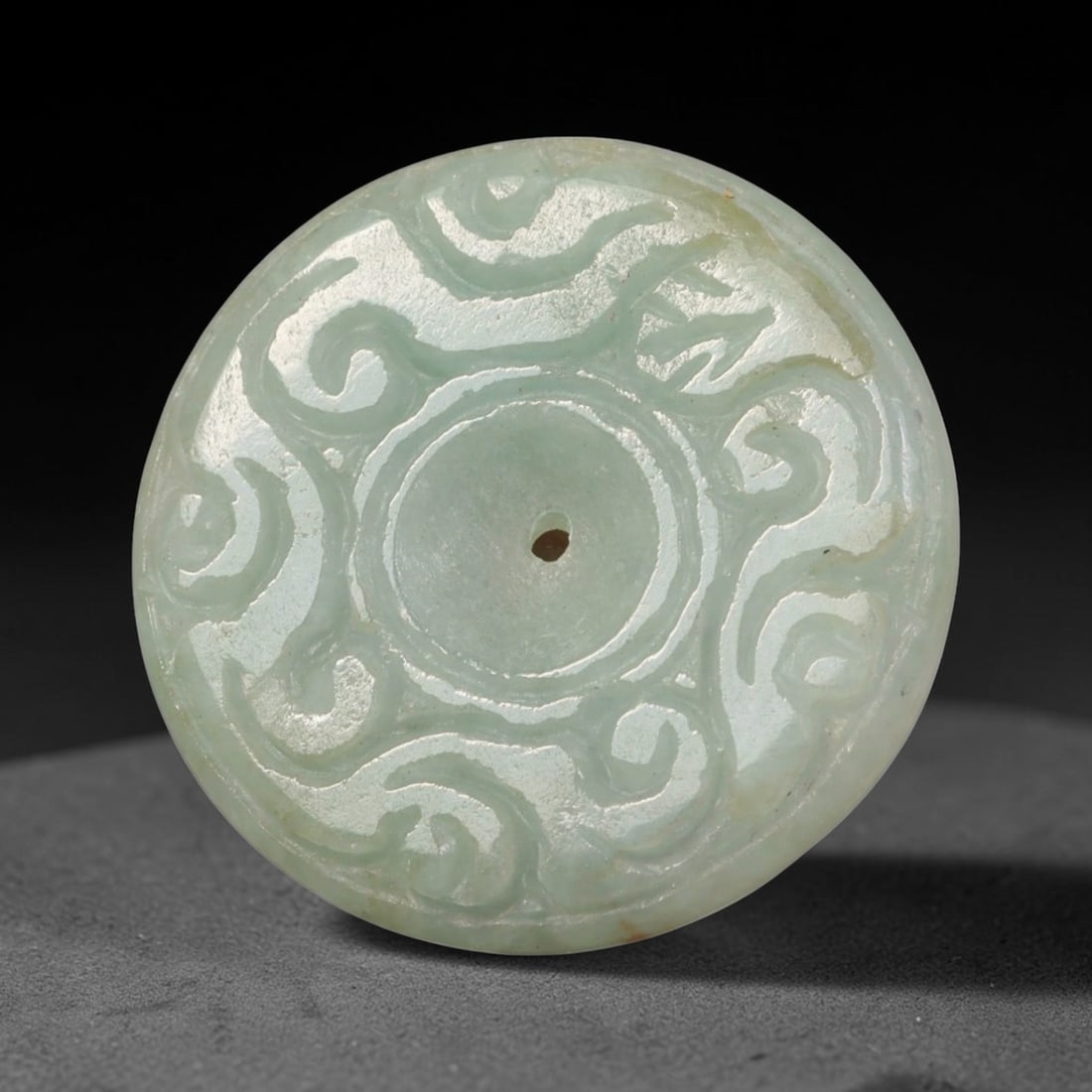 Natural Burmese Type A Jadeite Jade Carved Disc Pendant, 35BP: Artisan hand-carved untreated Burmese Type A jadeite jade circular disc pendant with a 27 mm diameter. The surface is adorned with detailed traditional relief carving finished with a smooth polished s
