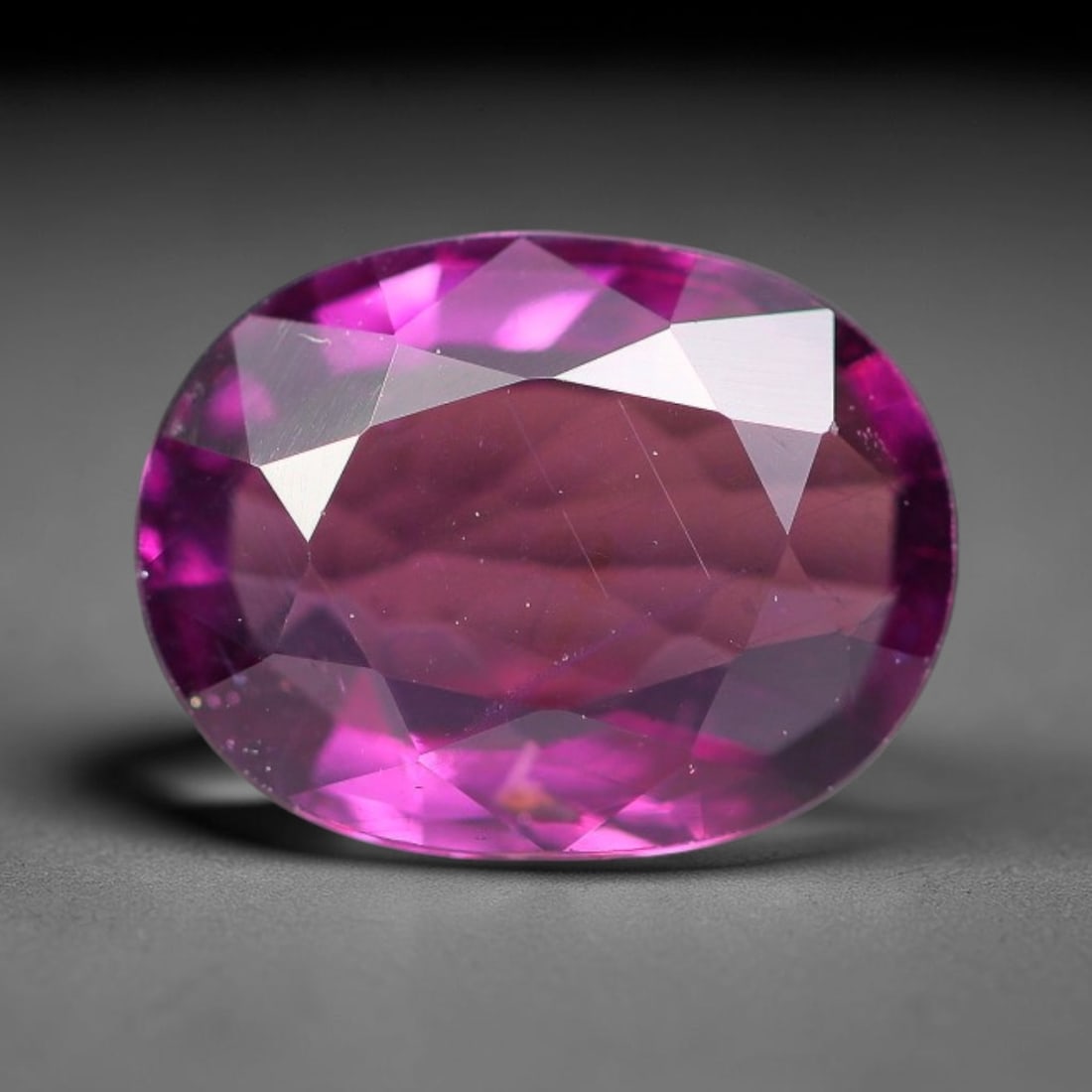 1.49ct Natural Tanzanian Rhodolite Grape Garnet Faceted Loose Gemstone, 89BF: This expertly faceted grape garnet, a scarce saturated purple-magenta rhodolite variant, features transparent crystal structure dotted with faint microscopic mineral specks within its precisely cut re