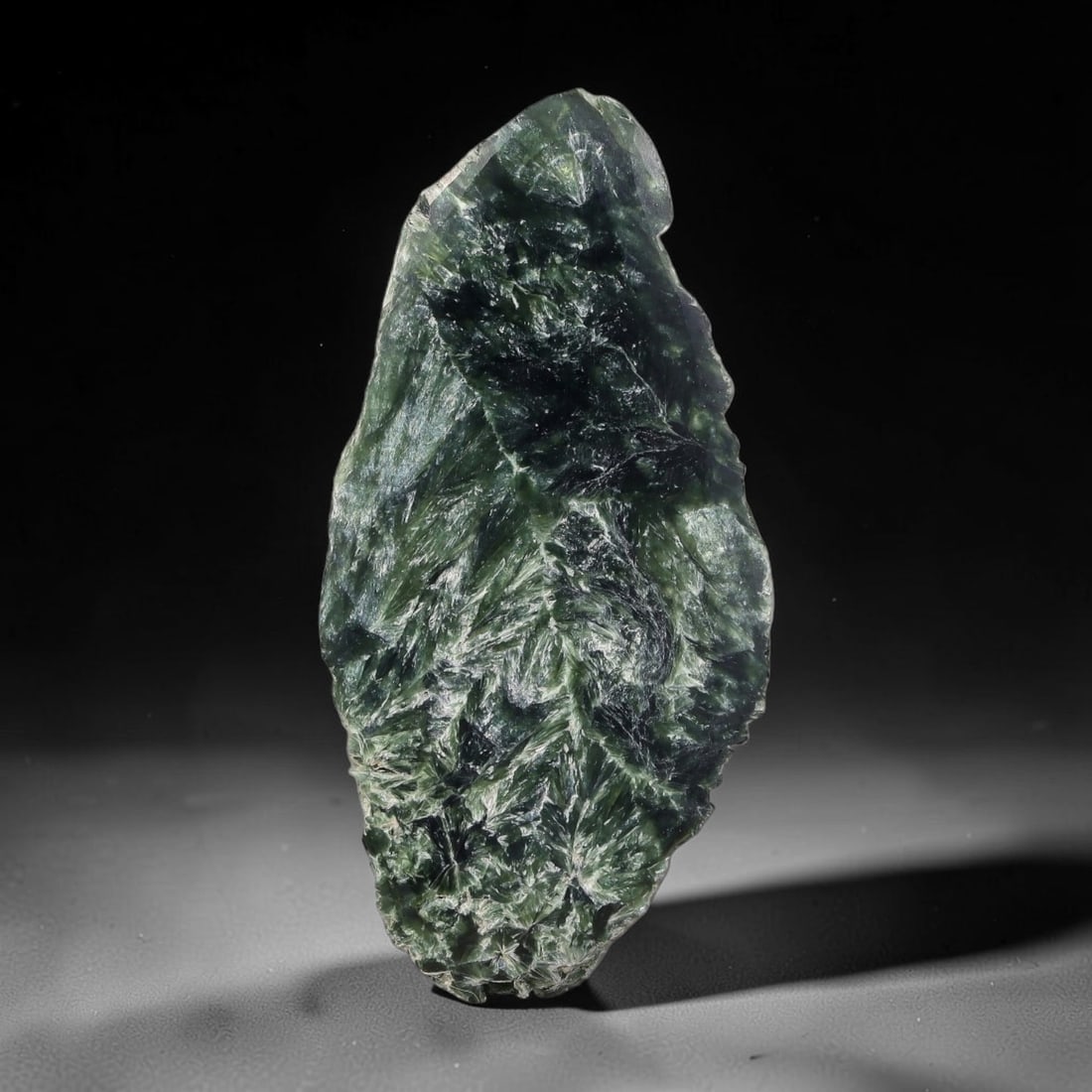 90ct Natural Siberian Seraphinite Polished Rough Slab, 22AR: This polished mineral slab is natural seraphinite originating from Siberian deposits, displaying characteristic radiating crystalline fibrous formations with layered deep forest and silvery green band