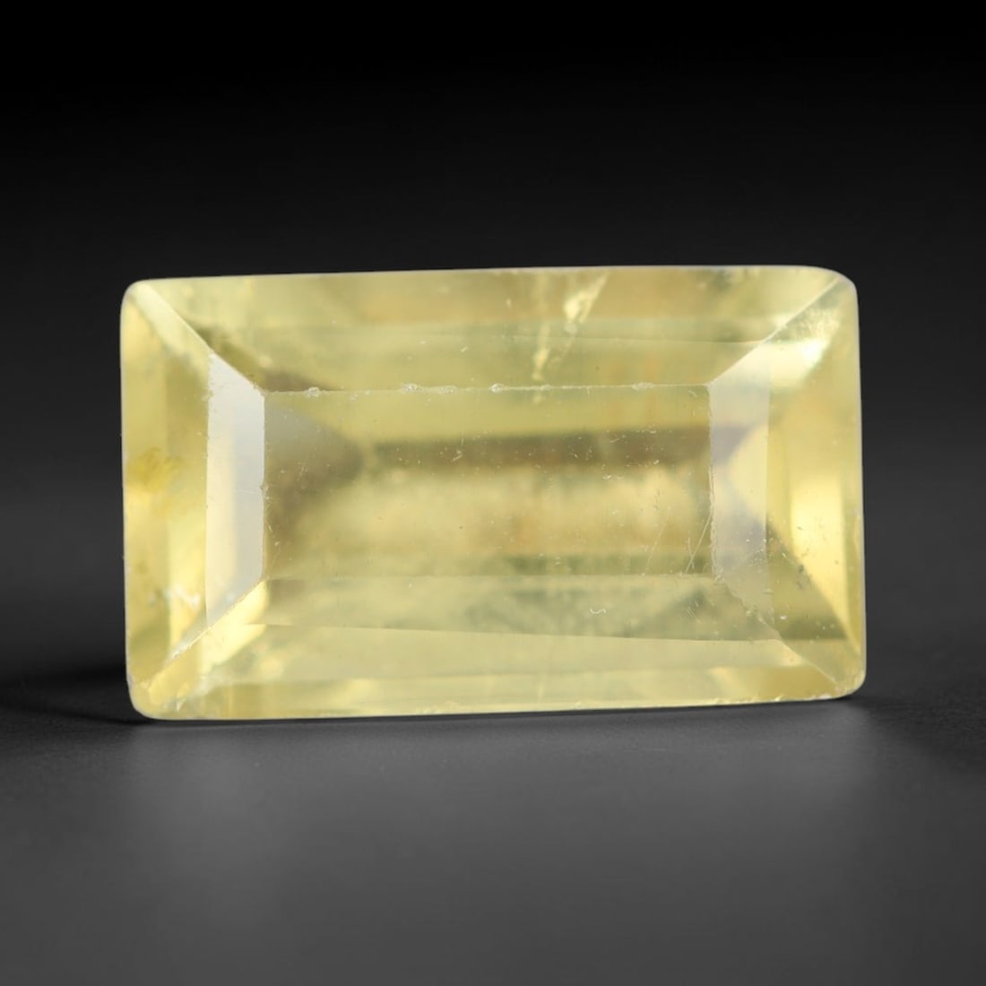 2.20ct Natural Mexican Lemon Yellow Faceted Apatite Loose Gemstone, 90AR: This expertly faceted yellow apatite holds translucent pale lemon yellow crystal structure with faint tiny internal mineral specks and subtle fine linear markings visible beneath its precisely polishe