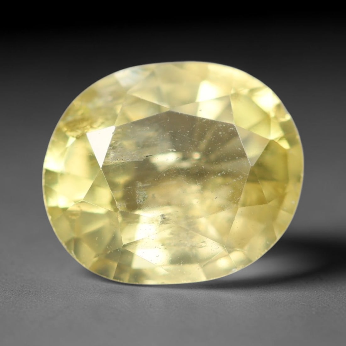 2.03ct Natural Mexican Lemon Yellow Faceted Apatite Loose Gemstone, 86AR: This expertly faceted yellow apatite holds translucent pale lemon yellow crystal structure with faint tiny internal mineral specks and subtle fine linear markings visible beneath its precisely polishe