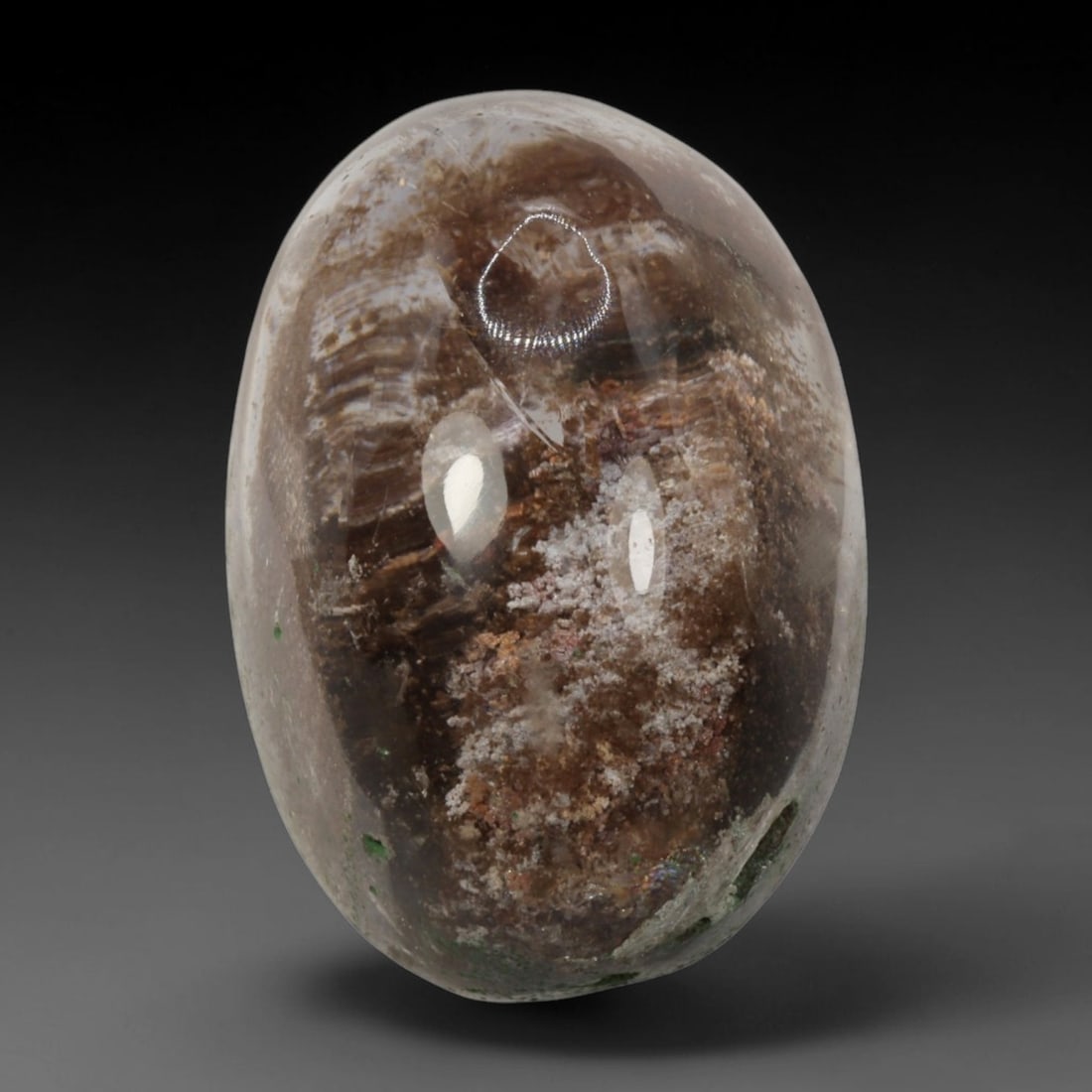 29ct Natural Brazilian Phantom Quartz Oval Cabochon Loose Gemstone, 2BM: This smoothly polished cabochon of natural phantom quartz preserves delicate layered phantom crystal formations enclosed inside transparent quartz host. The domed polished surface offers unobstructed 