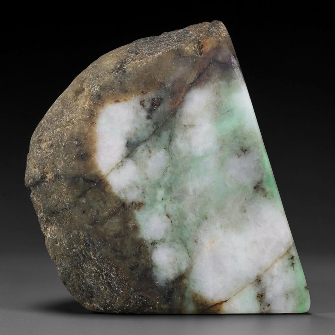 295ct Natural Type A Burmese Jadeite Jade Sliced Rough, 69FB: This specimen is a sliced rough block of natural Type A Burmese jadeite jade. The interior displays natural colour zoning with visible mineral veining and crystalline patterns typical of unprocessed j