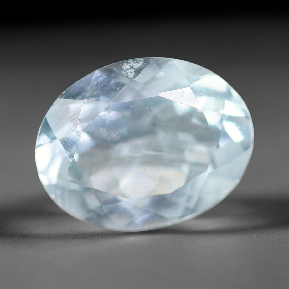 1.48ct Natural Brazilian Sky Blue Faceted Aquamarine Loose Gemstone, 10BF: This precisely faceted aquamarine boasts clear translucent pale sky blue body tone with subtle thin mineral needle and tiny scattered crystalline specks visible within its polished reflective planes i