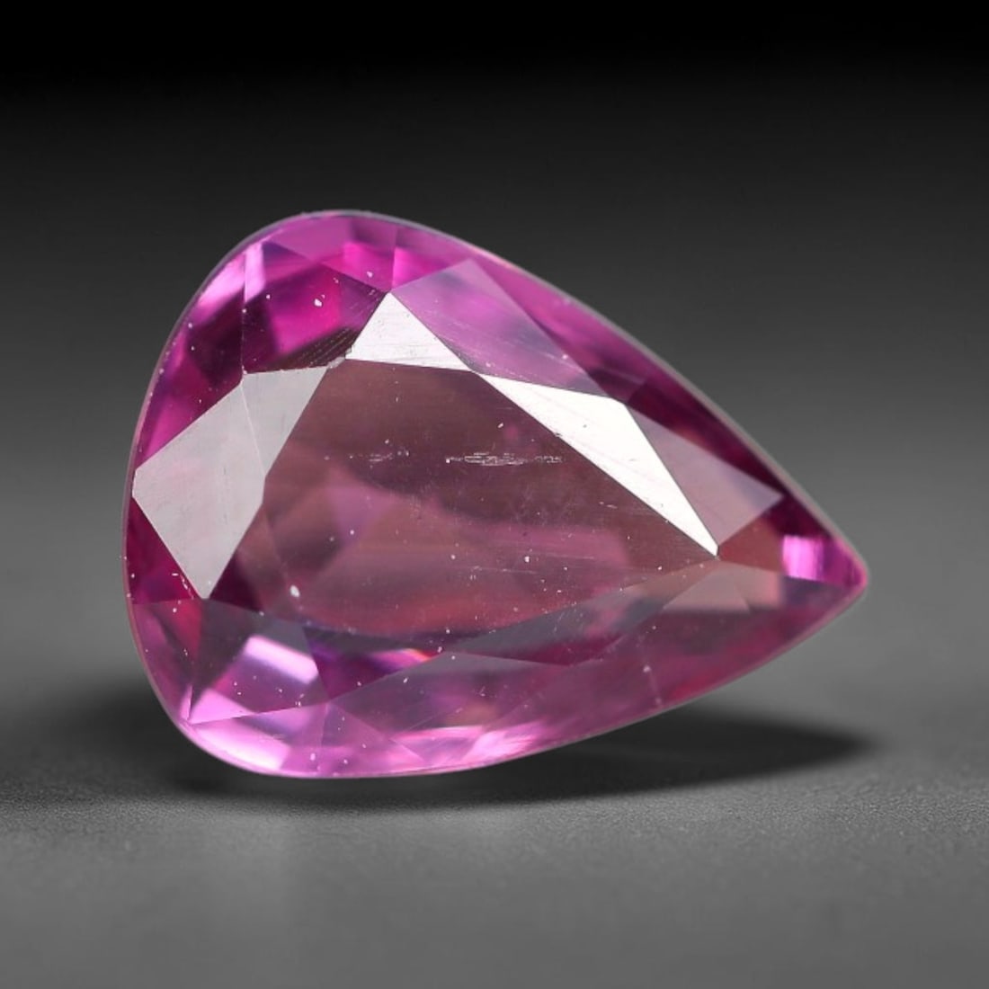 1.20ct Natural Tanzanian Rhodolite Grape Garnet Faceted Loose Gemstone, 8BE: This expertly faceted grape garnet, a scarce saturated purple-magenta rhodolite variant, features transparent crystal structure dotted with faint microscopic mineral specks within its precisely cut re