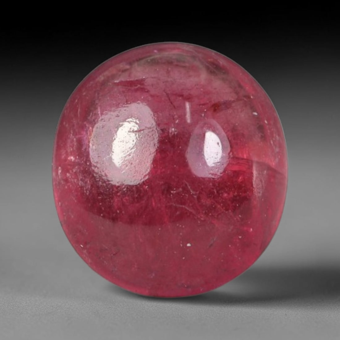 1.32ct Natural Brazilian Rubellite Tourmaline Cabochon Loose Gemstone, 43BC: This smoothly polished cabochon rubellite tourmaline features layered saturated pink-red body saturation with dense natural crystalline mineral flecks and fine internal fracture markings concentrated 