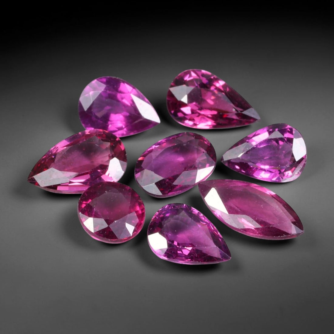 7.72ct Natural Mozambican Raspberry Pink Rhodolite Garnet Loose Gemstone Parcel Lot, 81EV: This dazzling parcel of rhodolite garnet displays rich raspberry-pink and deep magenta tones, brought alive by sharp faceting that delivers vivid sparkle across cushion, oval and pear shapes. Vibrant 