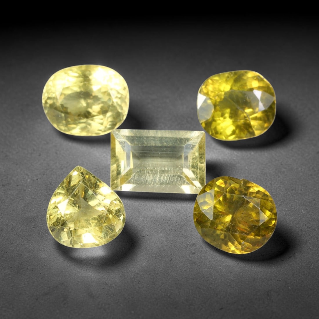 8.38ct Natural Madagascan Lemon Yellow Apatite Loose Gemstone Parcel Lot, 46EV: This bright parcel of apatite exhibits vivid lemon-yellow and golden-yellow hues across mixed oval, pear, cushion and emerald cut forms. Sharp faceting delivers lively sparkle, with warm sunny colour 