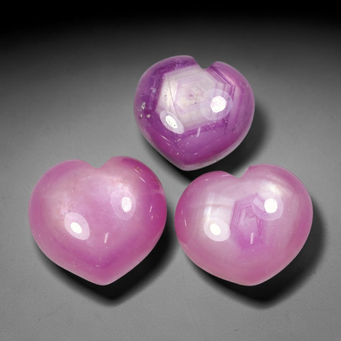41.24ct Natural Mozambican Ruby Cabochon Loose Gemstone Parcel Lot, 71EV: This distinctive parcel of heart-shaped ruby cabochons displays rich saturated magenta-red colour with visible hexagonal internal growth patterns across smooth polished domed surfaces. Each heart-form