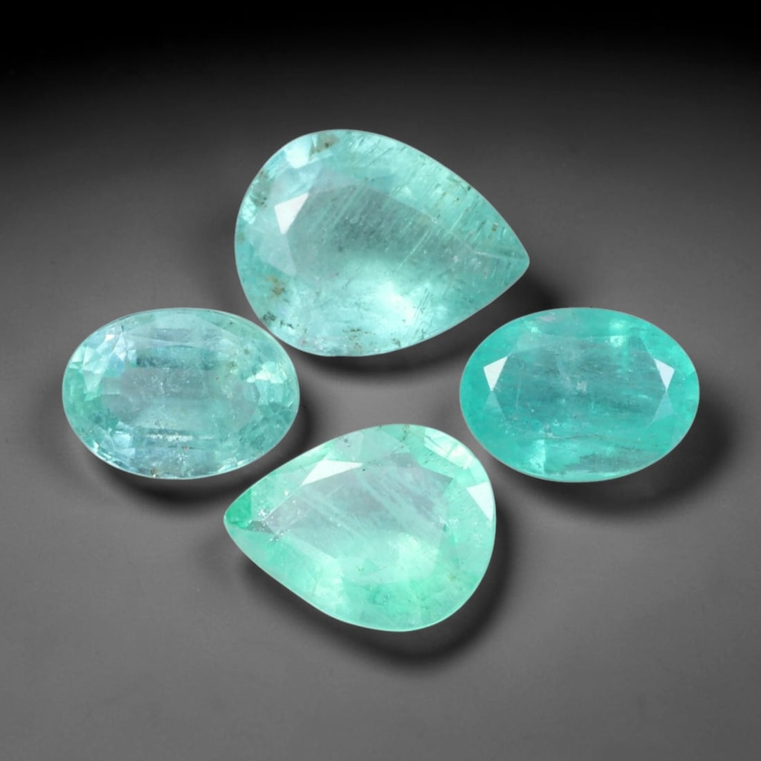 4.05ct Natural Zambian Vivid Green Emerald Loose Gemstone Parcel Lot, 66EV: This curated parcel of faceted emeralds delivers rich vivid green tones with soft internal glow, displaying natural textural details across well-proportioned oval cuts. Light passes through each gem t