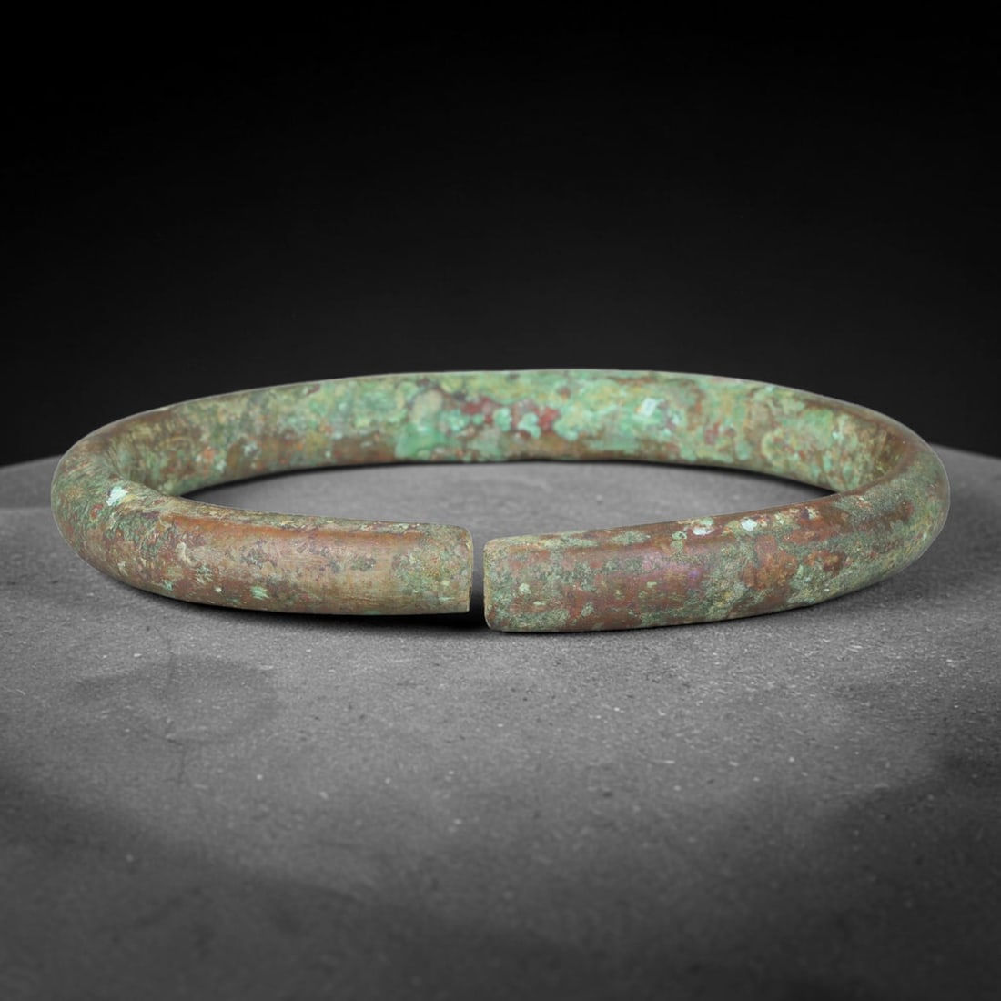 Ancient Roman Republic & Imperial Roman Bronze Open Armilla Bracelet (509 BCE-476 CE), 60ER: This antique solid bronze open cuff armilla bracelet originates from Roman Republic & Imperial Roman Culture, widely produced utilitarian and symbolic adornment worn by civilian women and awarded as m