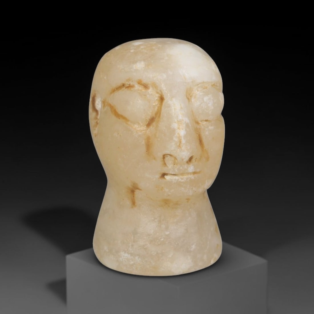 Ancient Bactrian Marble Idol Head (250 BCE-200 CE), 1EF: This carved pale marble idol head originates from Greco-Bactrian Culture, a significant Silk Road civilization blending Hellenistic and Central Asian artistic traditions. The simplified facial feature