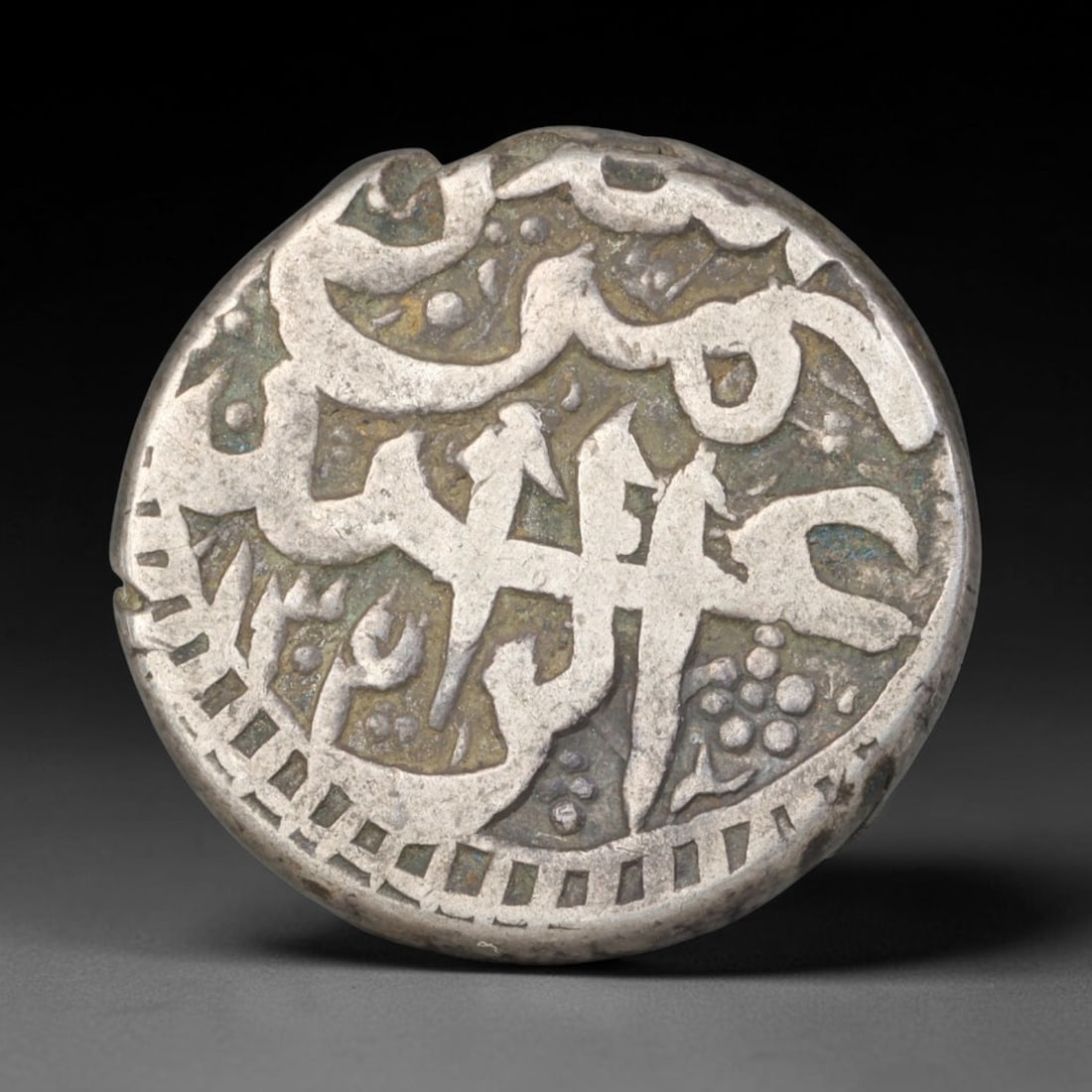 Antique Mughal Islamic Calligraphic Silver Coin (1526-1857 CE), 51EQ: This authentic silver coin originates from the Mughal Empire, struck with elegant flowing Islamic calligraphic script arranged across both obverse and reverse faces, characteristic of Mughal numismati