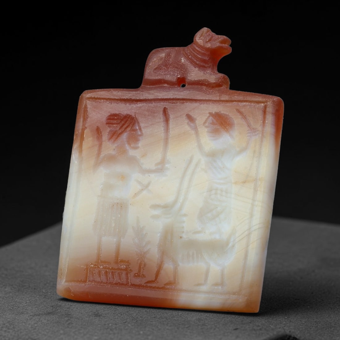 Vintage Natural Carnelian Agate Revival Indo-Persian Glyptic Figural Talisman Amulet Plaque, 14FK: This vintage talisman pendant plaque is skillfully carved from natural banded carnelian agate, crafted in a style referencing ancient Indo-Persian glyptic art traditions. The face bears detailed relie