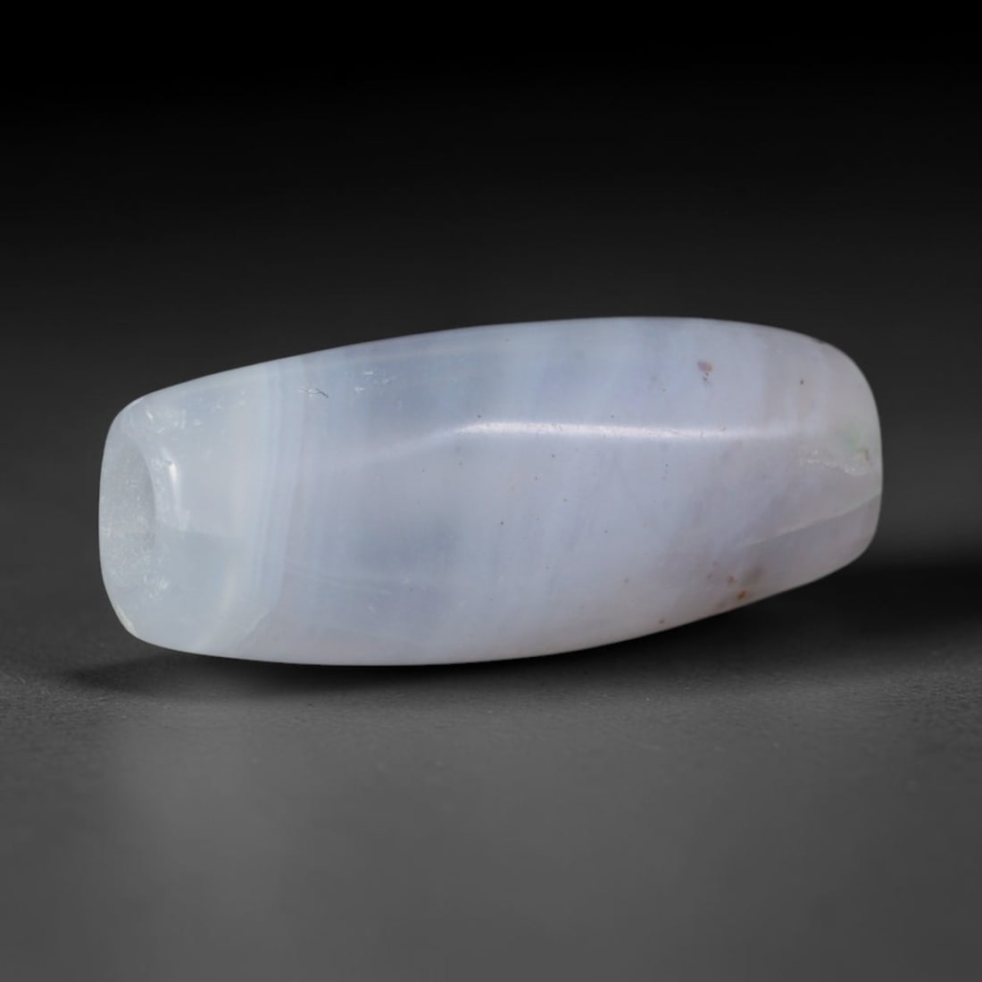 Ancient Medieval Qarakhanid Turkic Culture Banded Agate Barrel Bead (840-1212 CE), 30AD: This antique banded agate barrel bead originates from the Qarakhanid Turkic Culture, pivotal Central Asian Silk Road caravan artisans that manufactured agate trade beads for cross-continental markets 