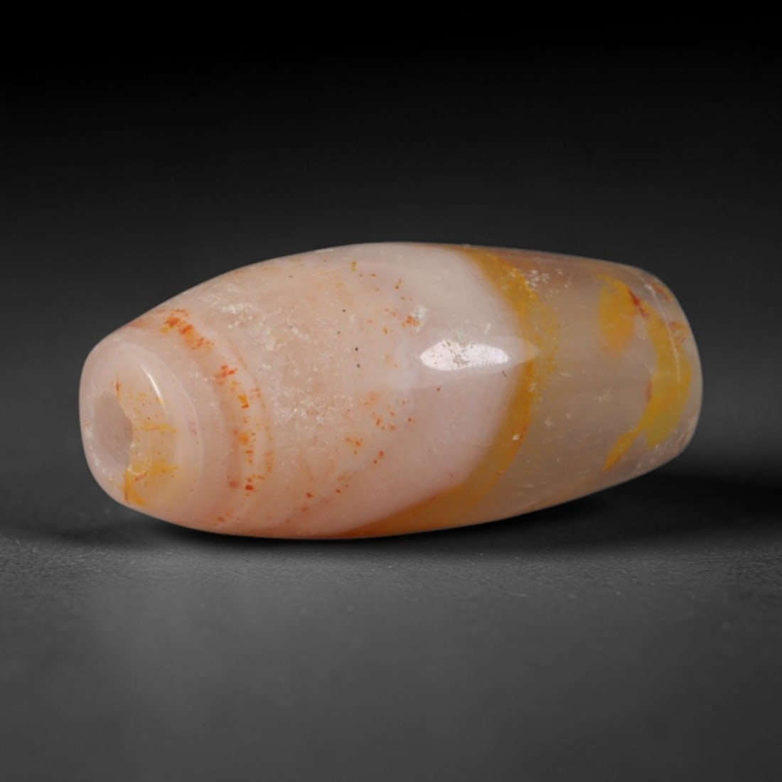 Ancient Timurid Central Asian Banded Agate Barrel Bead (1370-1507 CE), 98AC: This antique banded agate barrel bead originates from Timurid lapidary workshops of Central Asia, craftspeople who elevated Persian chalcedony carving traditions to produce wearable talismans for elit