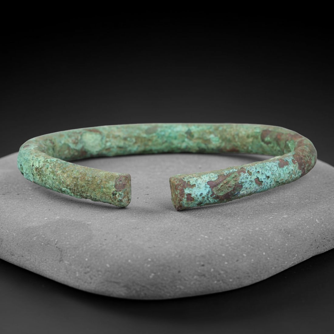 Ancient Roman Bronze Bangle Bracelet (100BCE-400 CE), 37EK: This antique bronze bangle bracelet originates from ancient Roman cultural tradition, created as wearable personal adornment. The metal displays thick, layered burial-formed patina across its surface,