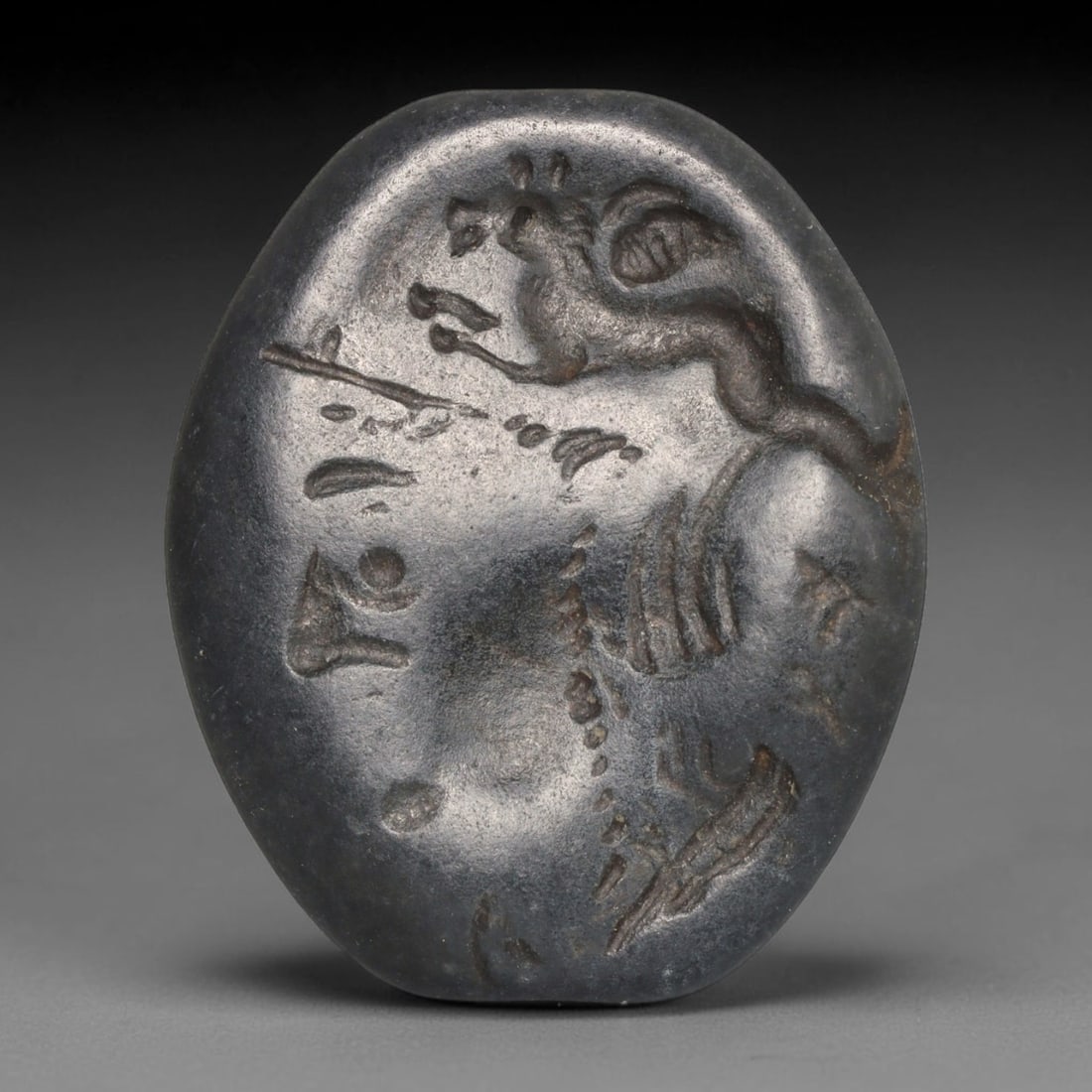 Ancient Sasanian Persian Dark Stone Intaglio Bead (224-651 CE), 95EC: This antique polished dark stone intaglio bead originates from the Sasanian Persian Empire, celebrated for wearable glyptic talismans circulated widely across the late antique Near East and Silk Road 