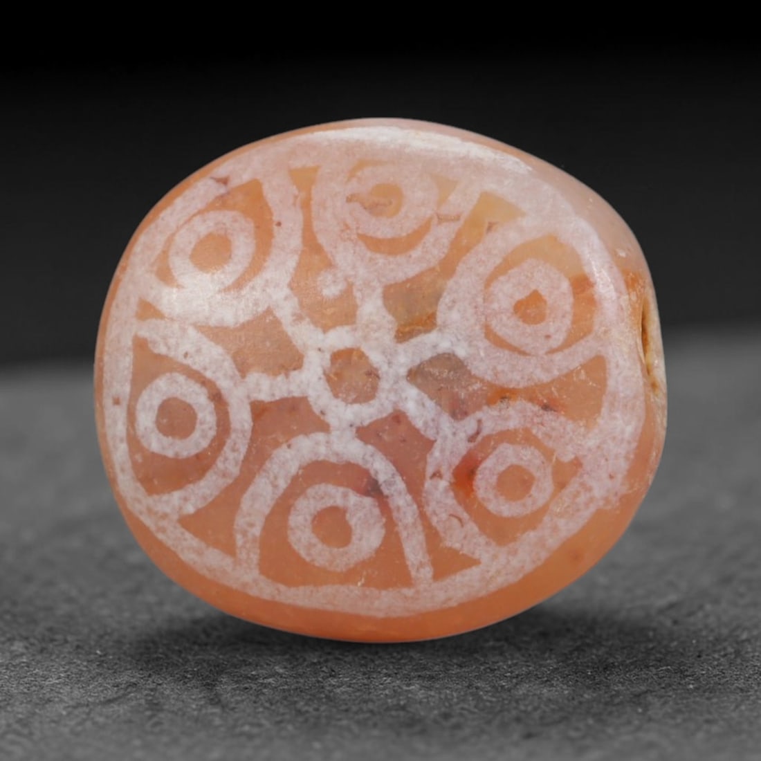 Antique Sino-Himalayan Region Etched Carnelian Bead, 73EG: Antique etched carnelian bead originating from the Sino-Himalayan region. Exhibits characteristic surface patina and traditional etched white decoration. Dimensions: 14x13mm, fully pierced for suspens