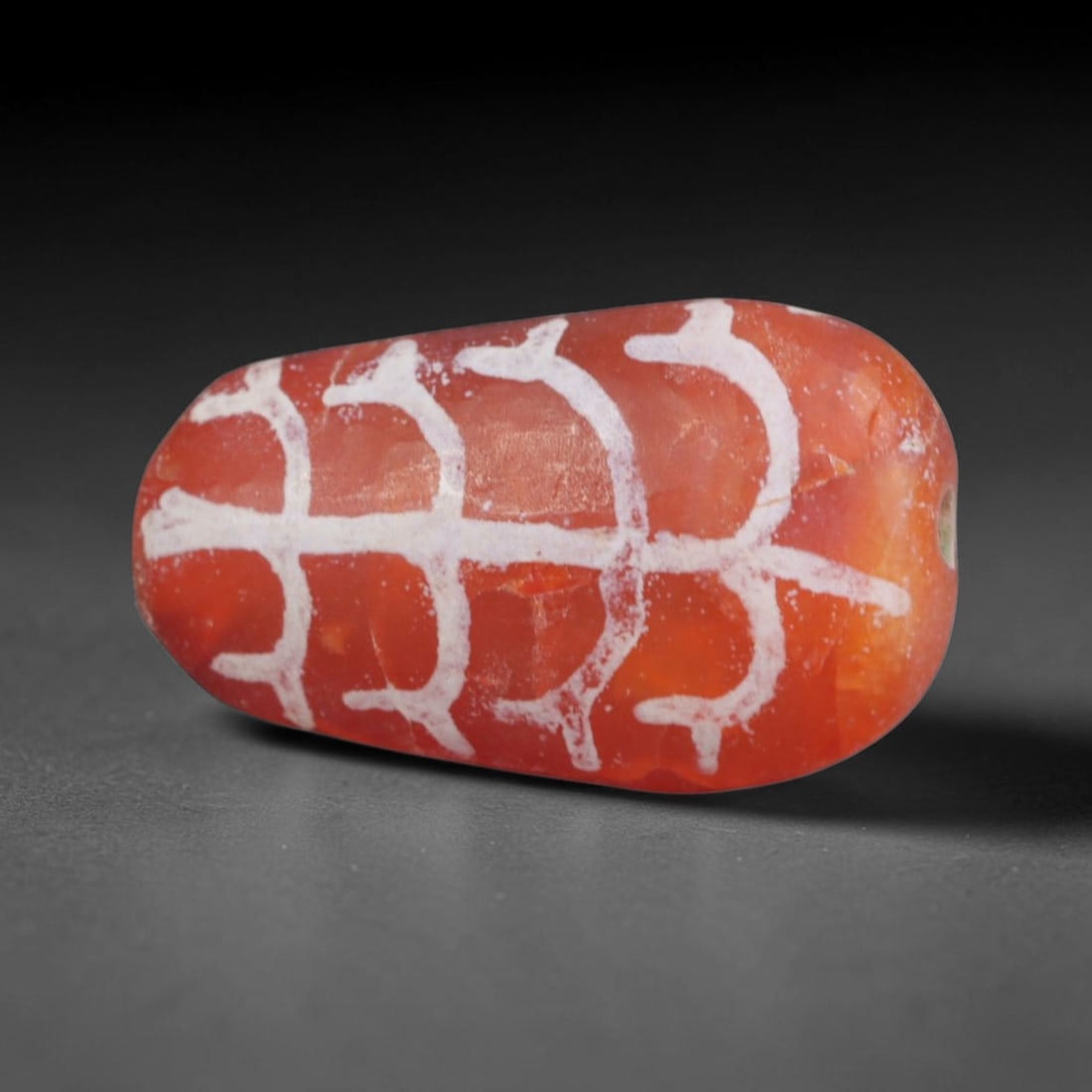 Antique Sino-Himalayan Region Etched Carnelian Bead, 87EG: Antique etched carnelian bead originating from the Sino-Himalayan region. Exhibits characteristic surface patina and traditional etched white decoration. Dimensions: 17x10mm, fully pierced for suspens