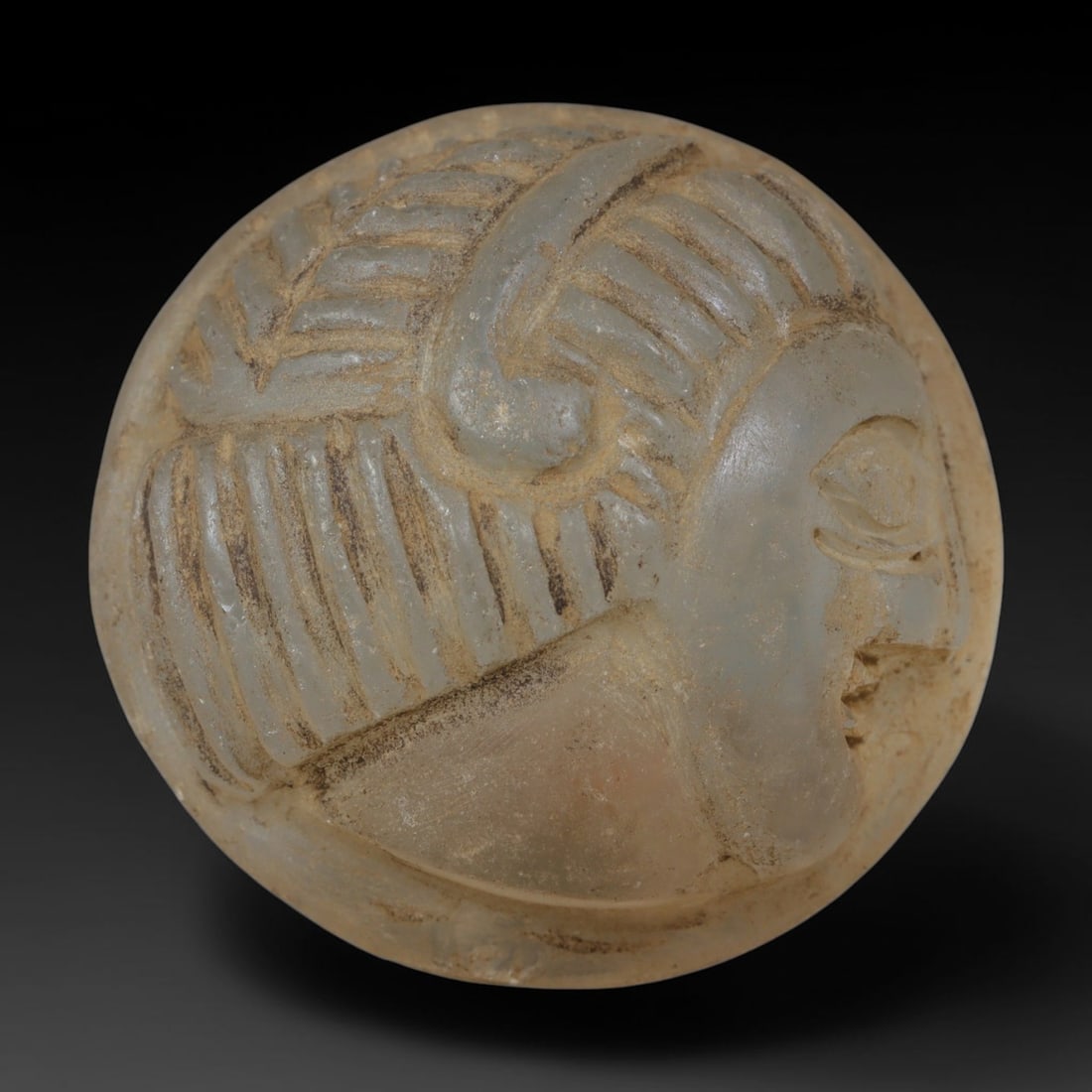 Ancient Medieval Egyptian Hand Carved Glass Intaglio Bead Talisman, 87AP: Antique wearable ornament expertly worked from translucent ancient glass material, originating from Medieval Egyptian Nile Valley craft traditions. Glass was a prized artistic medium across Egyptian a