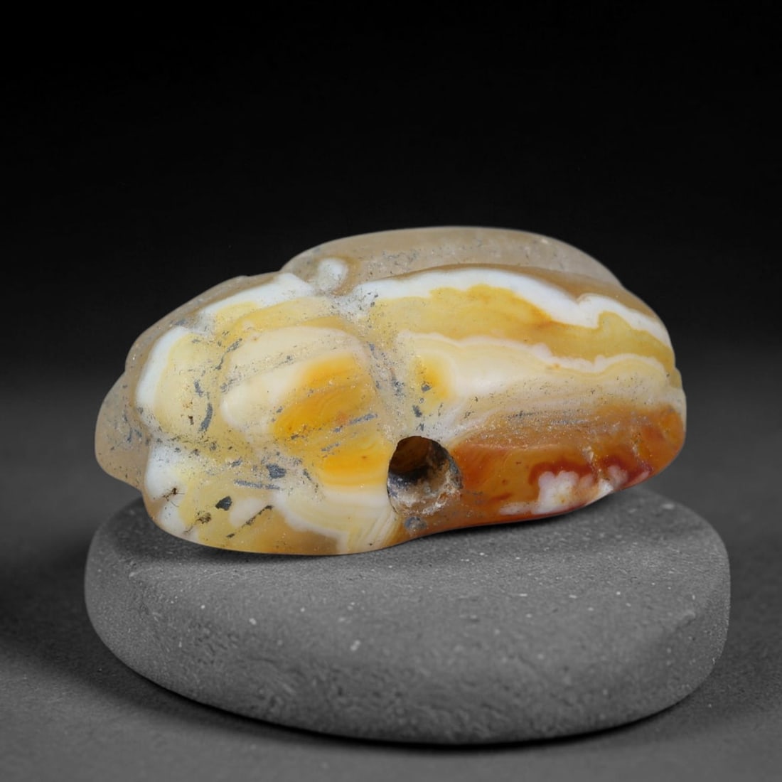 Ancient Pharaonic Egyptian Agate Scarab Amulet Bead (3100 BCE-30 CE), 23EC: This antique scarab amulet bead is carved from natural agate, originating from Pharaonic Egyptian culture. Scarabs were sacred protective talismans closely linked to rebirth and eternal life within an