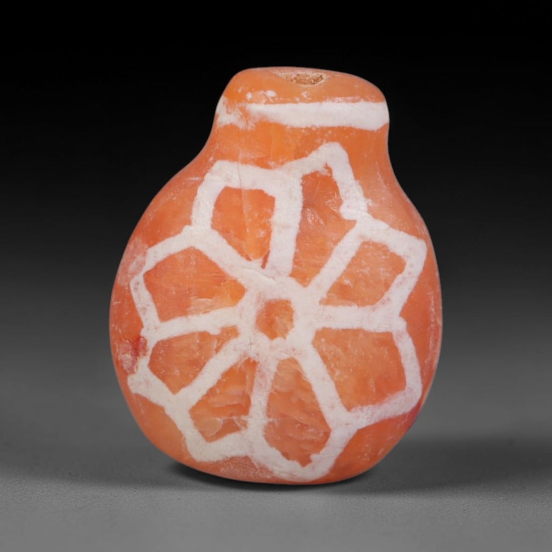 Antique Sino-Himalayan Region Etched Carnelian Bead, 99EG: Antique etched carnelian bead originating from the Sino-Himalayan region. Exhibits characteristic surface patina and traditional etched white decoration. Dimensions: 14x11mm, fully pierced for suspens