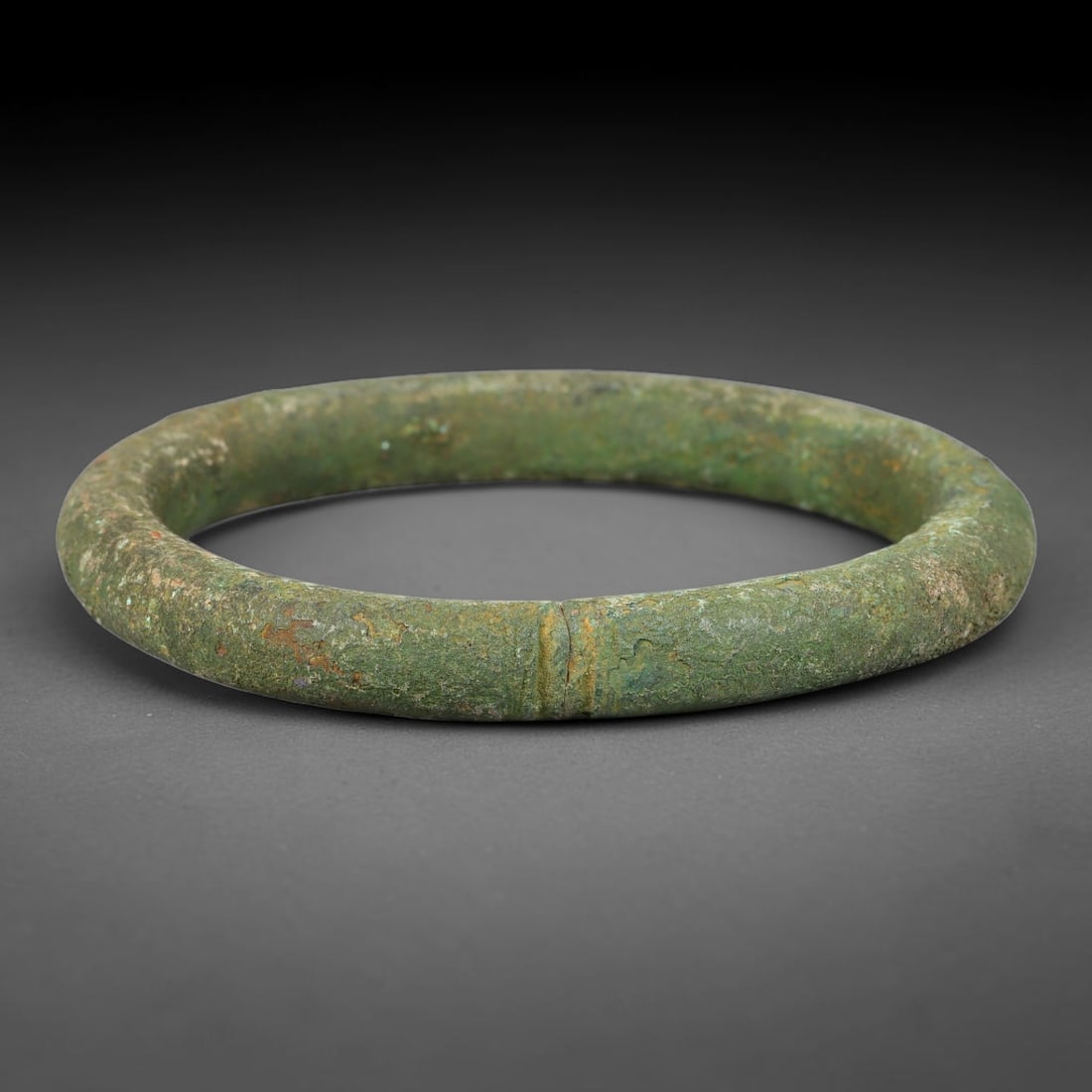 Ancient Roman Republic & Imperial Roman Bronze Open Armilla Bracelet (509 BCE-476 CE), 95AT: This antique solid bronze open cuff armilla bracelet originates from Roman Republic & Imperial Roman Culture, widely produced utilitarian and symbolic adornment worn by civilian women and awarded as m